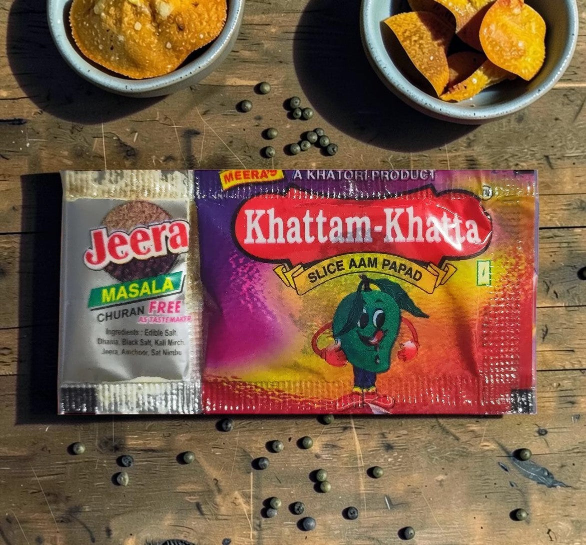 Desipan Khattam-Khatta Slice Aam Papad with a cartoon mango character and Jeera Masala churan free packet.