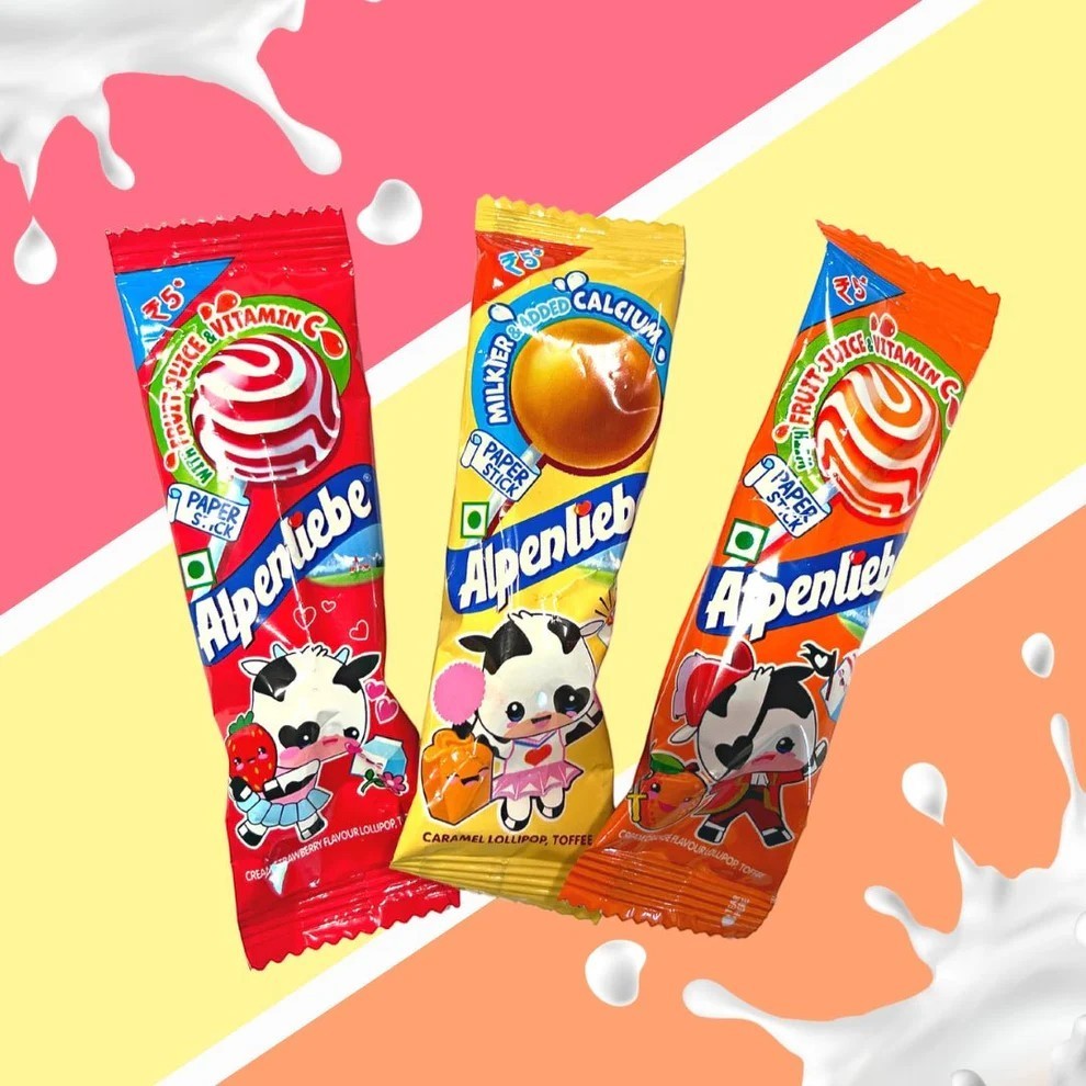 Desipan Alpenliebe lollipops in Strawberry, Caramel, and Orange flavors. Features paper sticks and cartoon cows.
