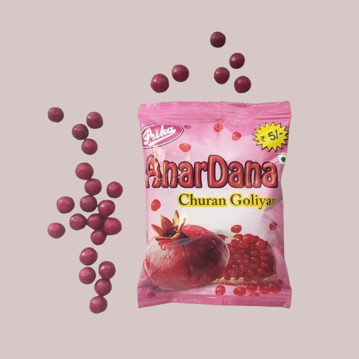 Desipan Anardana Churan Goliyan pomegranate candies, small round red treats coated in powder, with a pomegranate image on the pink packaging.
