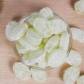 Desipan Assorted Fruit Flavored Hard Candies, light green, sugar-coated, oval shape, in a glass bowl.