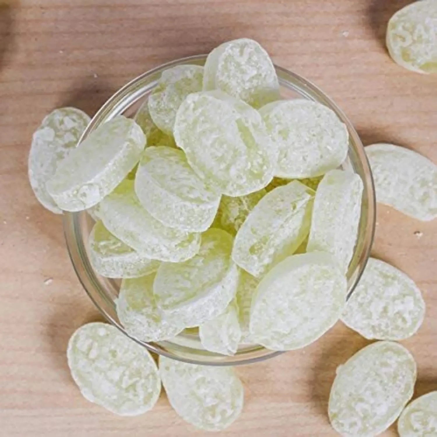 Desipan Assorted Fruit Flavored Hard Candies, light green, sugar-coated, oval shape, in a glass bowl.