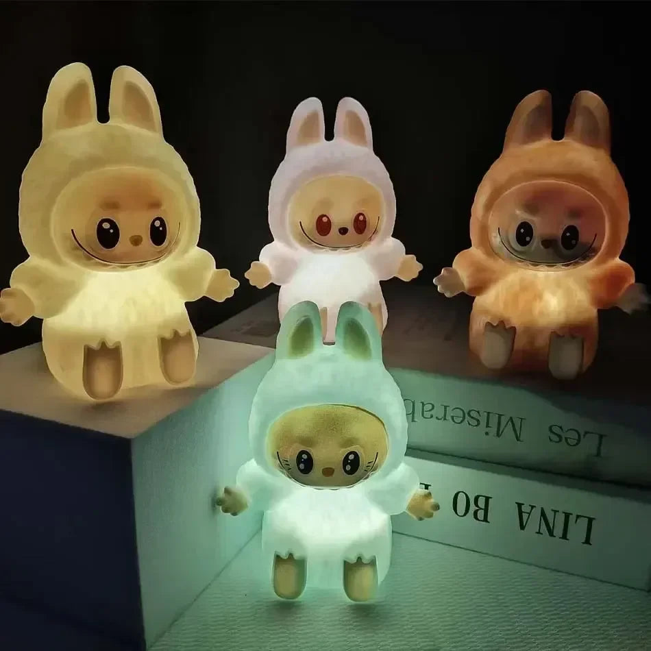 Desipan cute bunny character night light in soft translucent material, emitting warm glow. Available in yellow, pink, orange, and mint green.