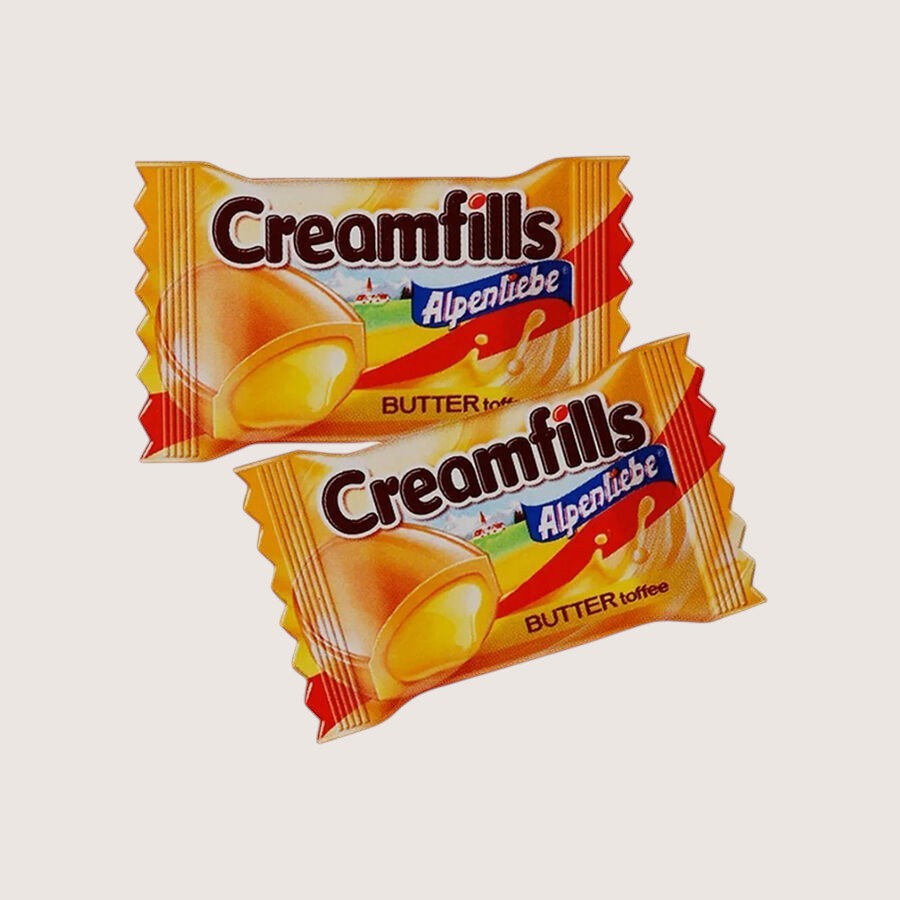 Desipan Creamfills Alpenliebe Butter Toffee candies with creamy center, individually wrapped in golden foil.