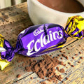 Desipan Cadbury Eclairs individually wrapped candy with purple and gold foil, featuring chocolate and caramel.
