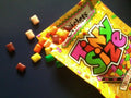 Desipan Chiclets Tiny Size chewing gum with colorful candy-coated pieces spilling from a vibrant yellow package.