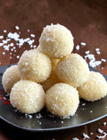 Desipan Coconut Snowball Cookies are small, round, white treats coated in shredded coconut.