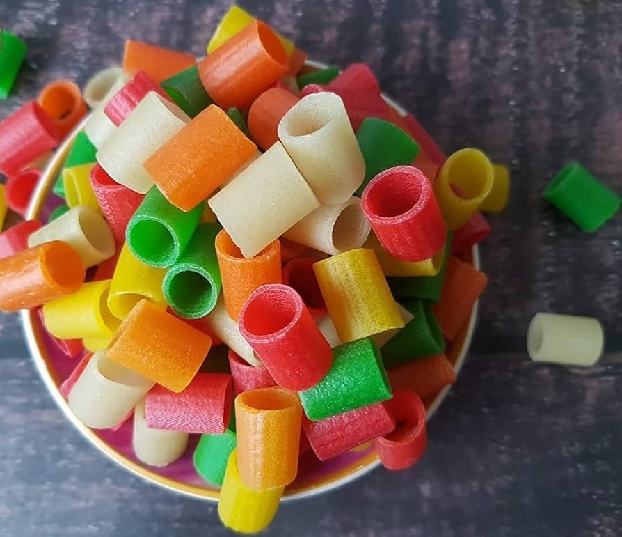 Desipan colorful tube-shaped fryums in a bowl, featuring vibrant red, yellow, orange, and green crispy snack pieces.