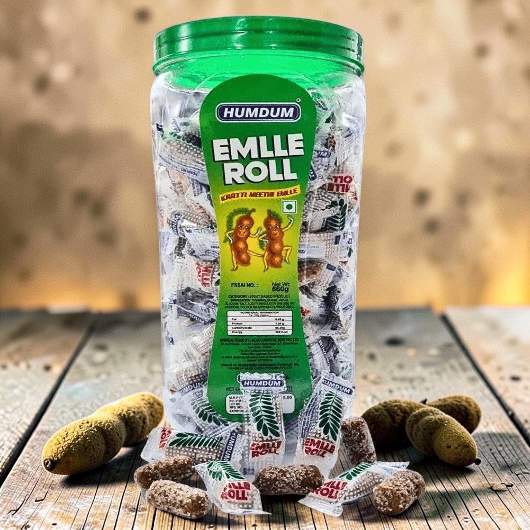 Desipan Humdum Emlle Roll tamarind candy in a large jar, individually wrapped, with loose candies scattered around.