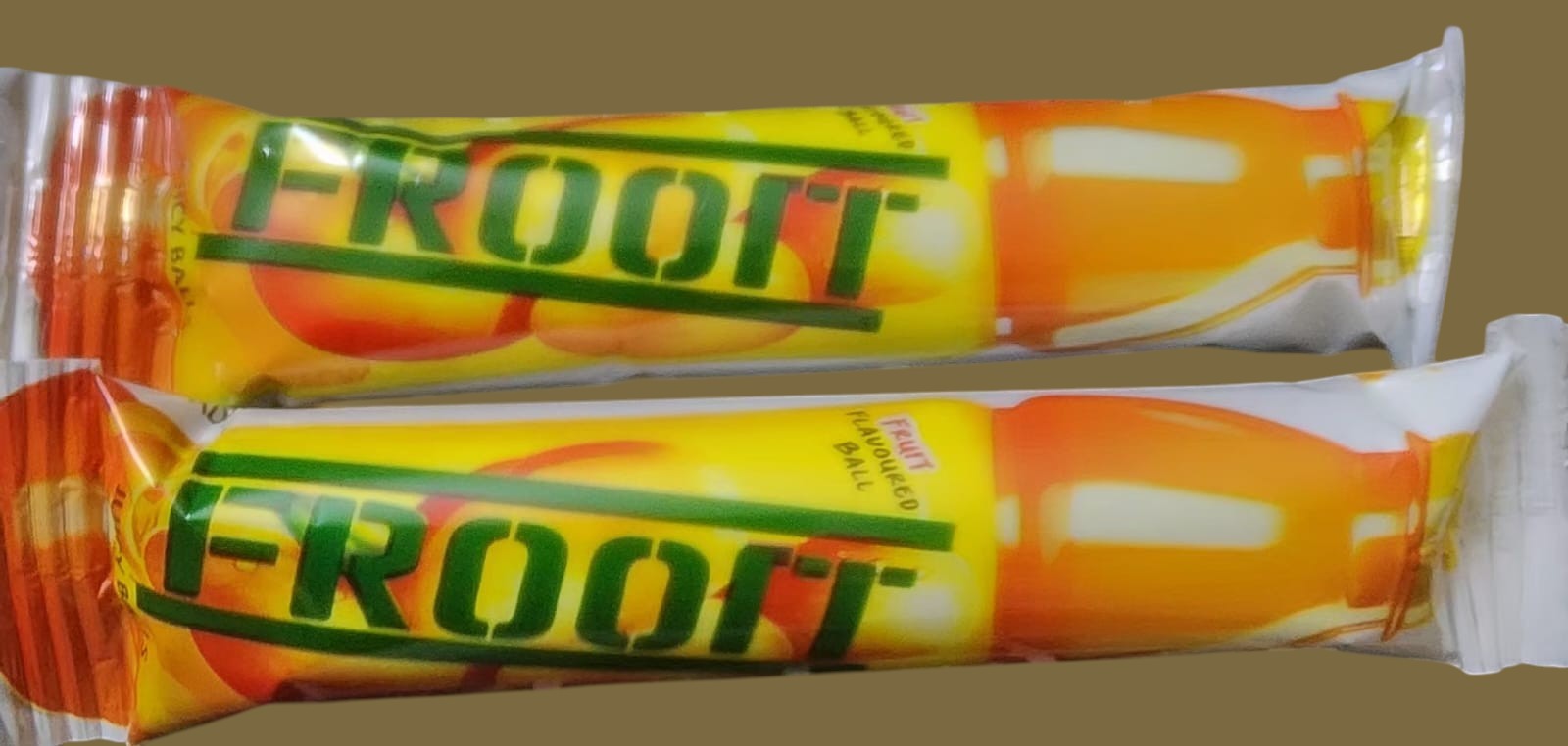 Desipan Froot Balls fruit-flavored candy in yellow and orange wrappers with fruit graphics.