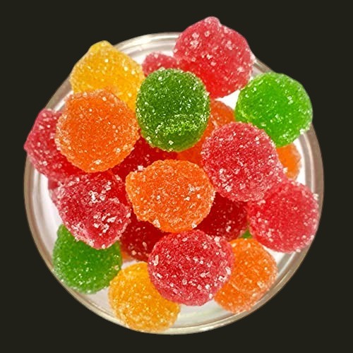 Desipan assorted fruit flavored gummy candies in red, orange, green, and yellow, coated in sugar.