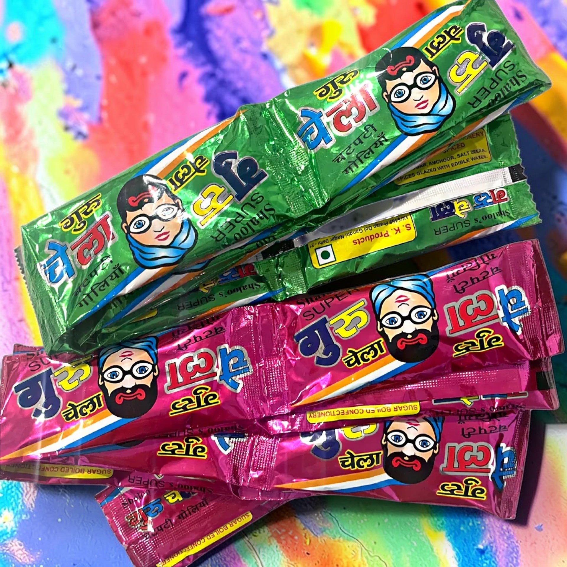 Desipan Guru Chela sugar boiled confectionery in green and pink packaging with cartoon faces.