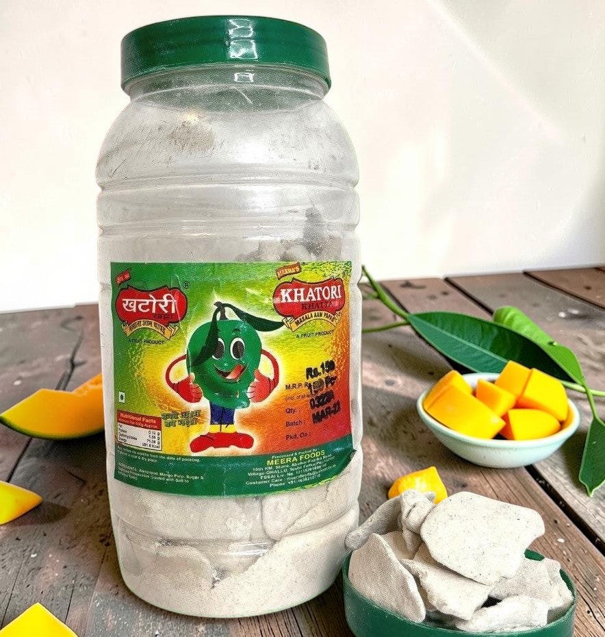 Desipan Khatore Masala Aam Papad fruit slices in a jar with a cartoon mango character on the label.