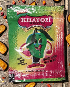 Desipan Khatta Masala Aam Papad packaging with a cartoon mango character. Green, yellow, and red foil.