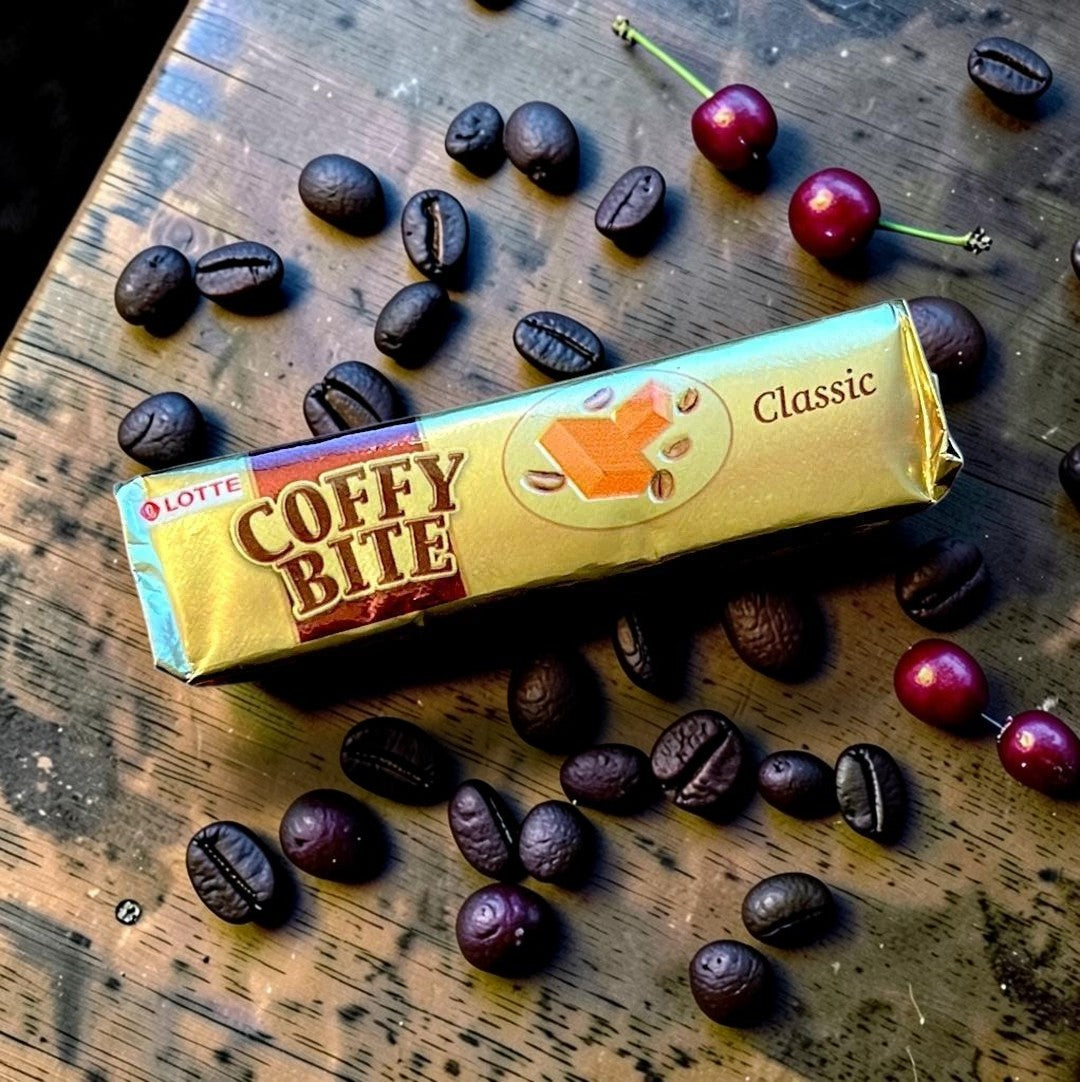 Desipan Lotte Coffy Bite Classic toffee candy with coffee beans and caramel cube graphic on gold wrapper.