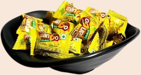 Desipan Mango Doubles chewy candies, individually wrapped in bright yellow packaging with mango graphics.