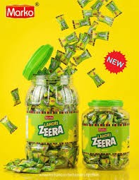 Desipan Marko Lahori Zeera candy in a large jar and smaller container, individually wrapped green candies with yellow accents.