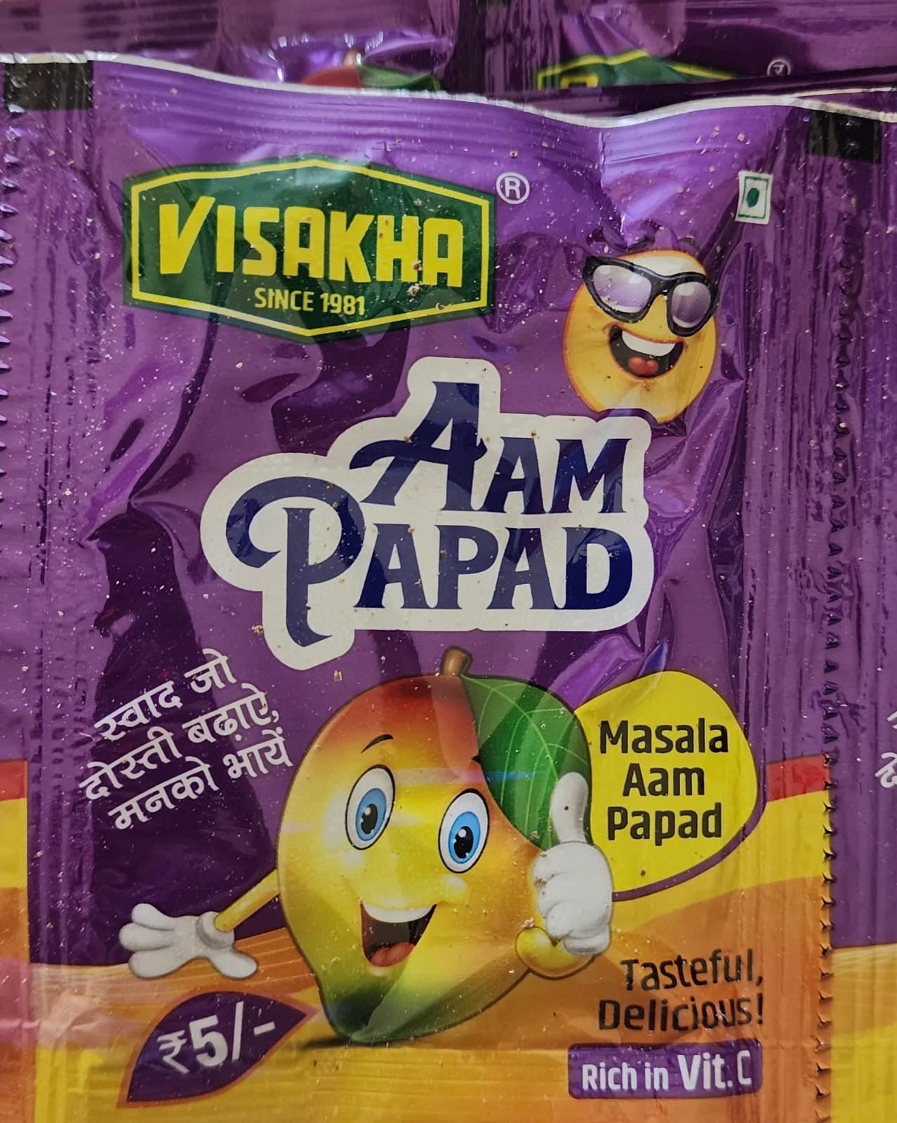 Desipan Masala Aam Papad fruit snack pouch featuring a cartoon mango character giving a thumbs up. Rich in Vit. C.