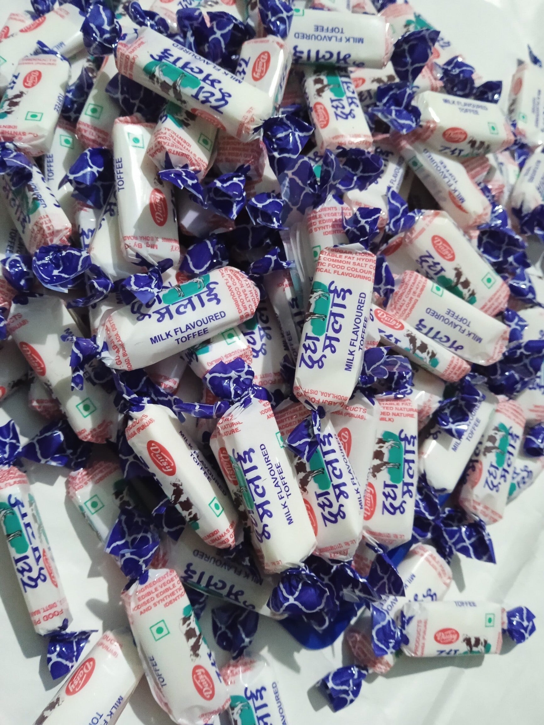 Desipan Milk Flavoured Toffees individually wrapped in blue and white foil with cow imagery. Classic creamy candy.