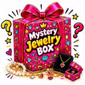 Desipan mystery jewelry gift box featuring a vibrant pink package with gold crowns, hearts, and diamond illustrations.