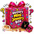 Desipan Mystery Mini Jewelry Box gift set featuring gold necklaces, heart gems, and pearls in festive pink packaging