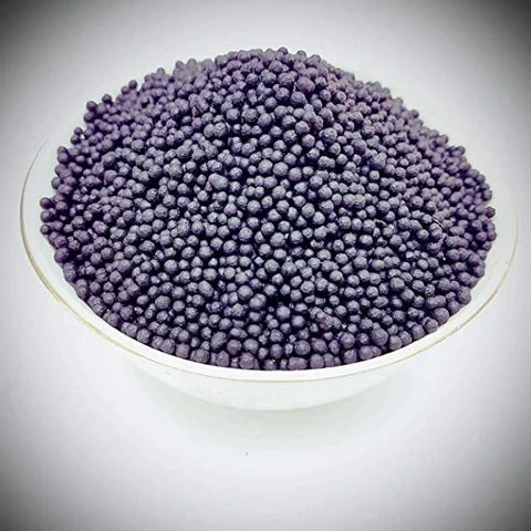 Desipan organic fertilizer granules in dark purple, slow-release pellets for plant health and growth.