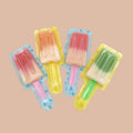 Desipan popsicle-shaped gummies in assorted fruit flavors and colors, individually wrapped.