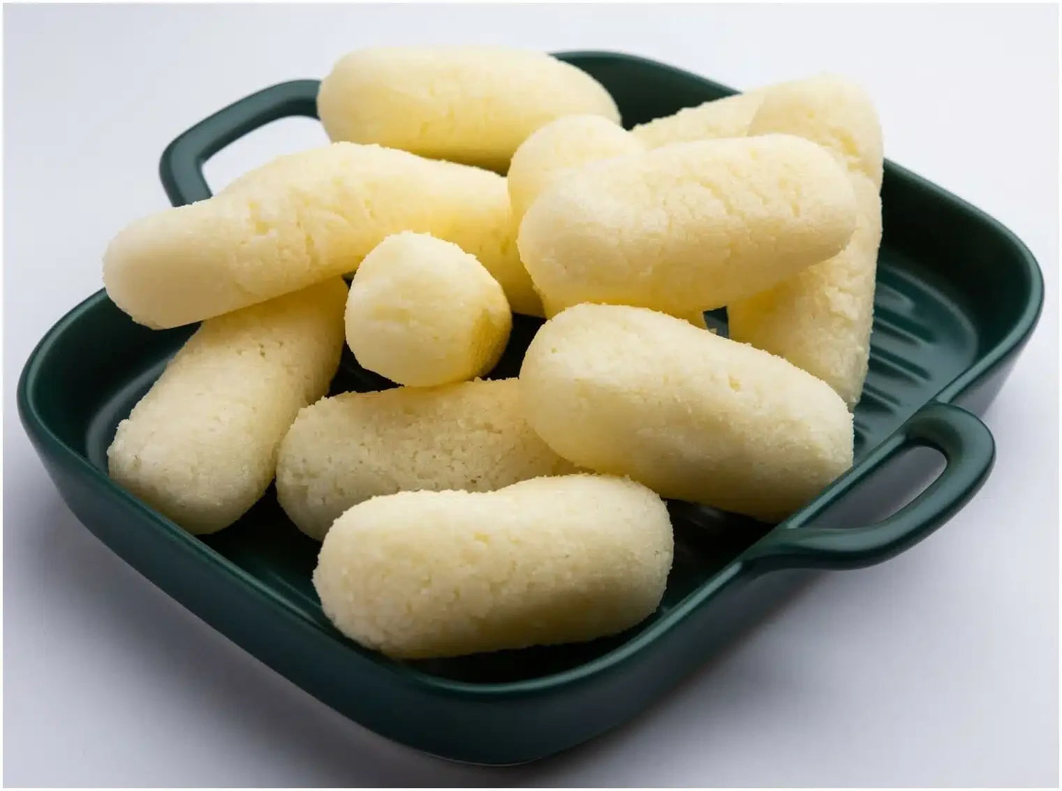 Desipan Rasmalai, soft spongy cottage cheese dumplings in creamy milk syrup, a traditional Bengali dessert.