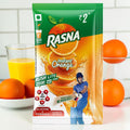 Desipan Rasna Instant Orange Rush Lite drink mix packet with oranges and a cricketer. Fortified with vitamins and minerals.