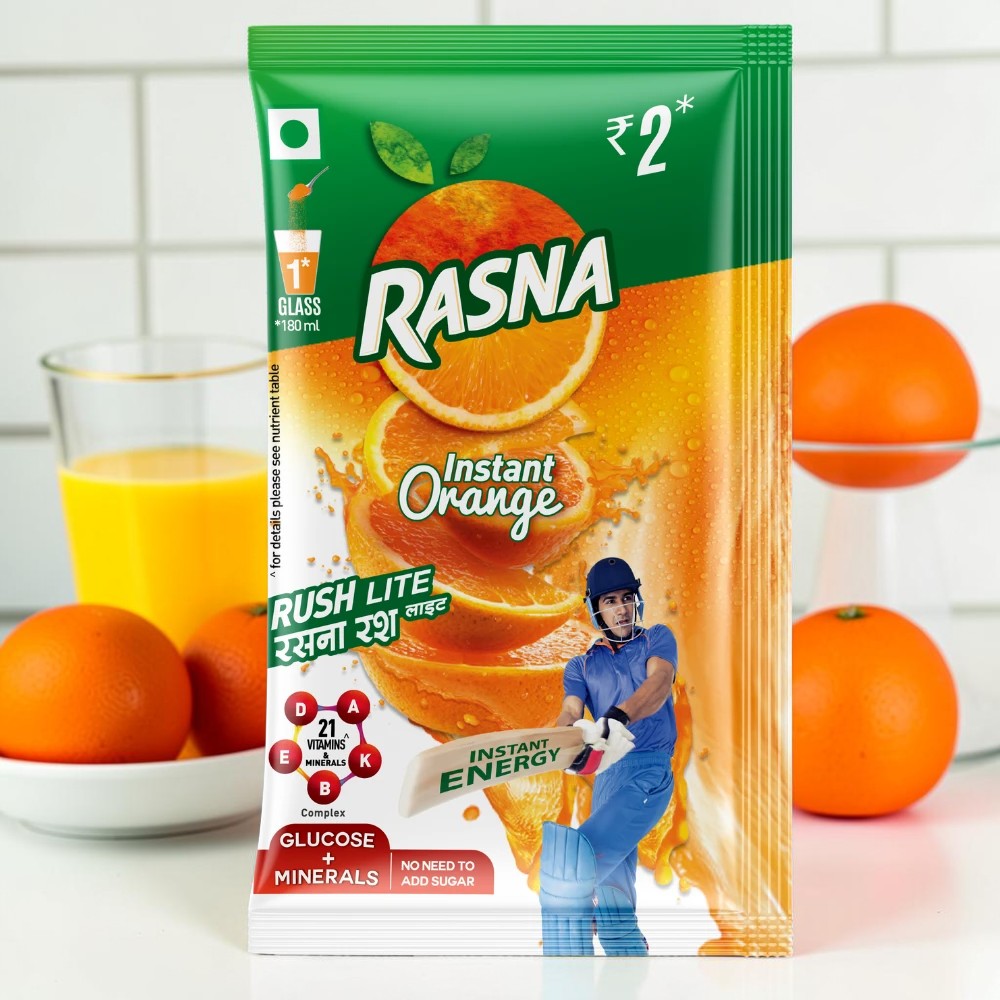 Desipan Rasna Instant Orange Rush Lite drink mix packet with oranges and a cricketer. Fortified with vitamins and minerals.