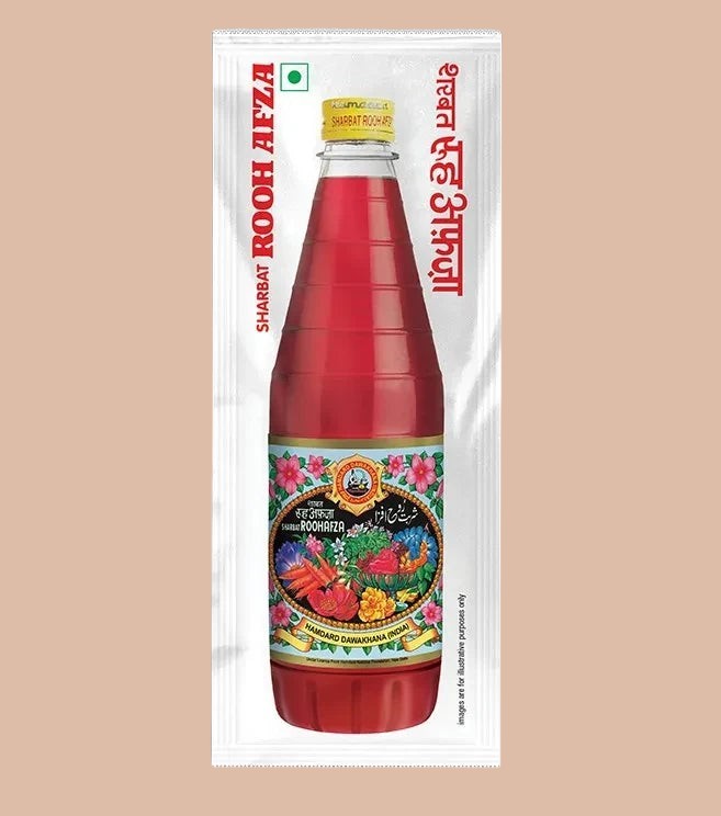 Desipan Sharbat Rooh Afza Drink Concentrate, a vibrant red herbal syrup in a glass bottle, perfect for refreshing beverages and desserts.
