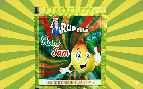 Desipan Rupali Aam Jam mango flavored candy powder packet with cartoon mango giving thumbs up.