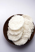 Desipan traditional sun-dried white sabudana papad discs made from tapioca pearls in a rustic wooden bowl