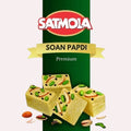 Desipan Satmola Premium Soan Papdi dessert squares topped with pistachios and apple slices.