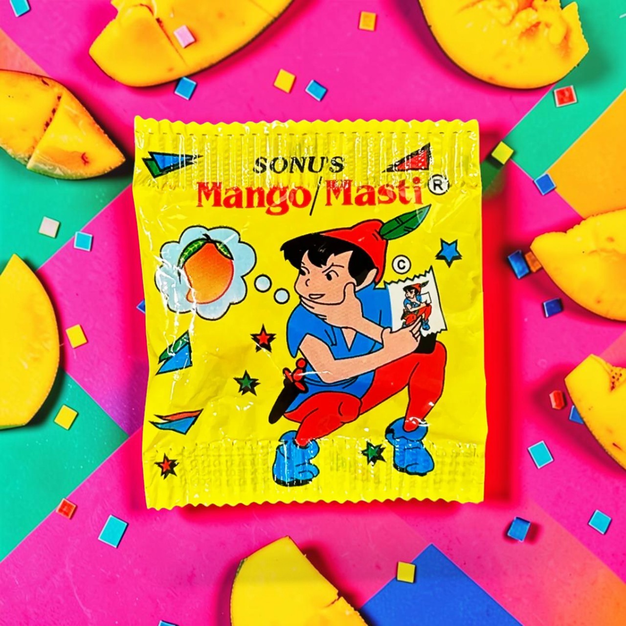 Desipan Sonu's Mango Masti candy wrapper with cartoon boy thinking of mangoes. Yellow wrapper with red and blue accents.