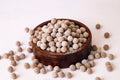 Desipan Traditional Indian Sweet Snack Balls, light brown tapioca pearls coated in sugar, in a wooden bowl.